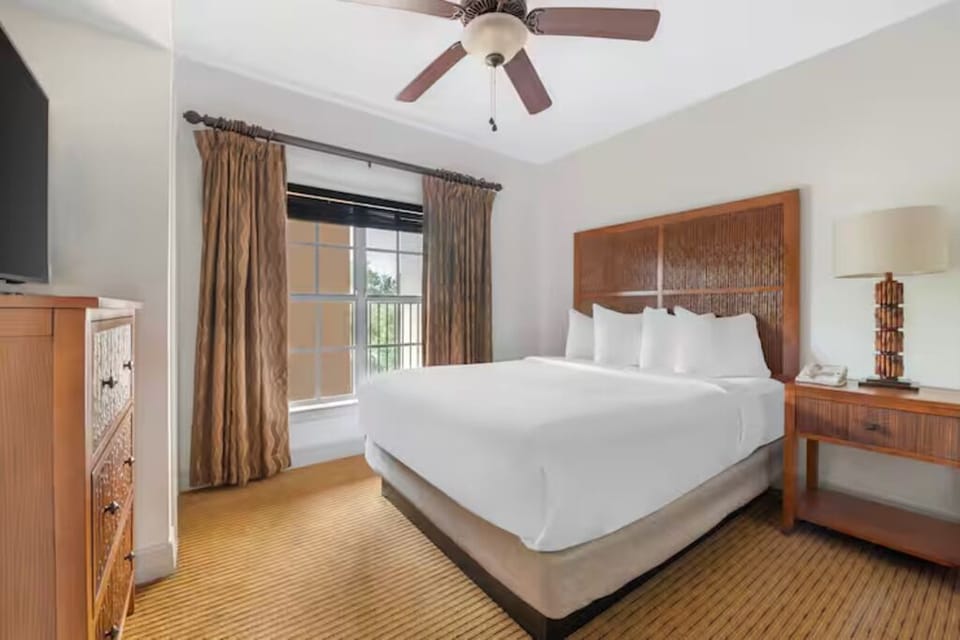 Settle into serene comfort with a cozy bed and soft lighting.