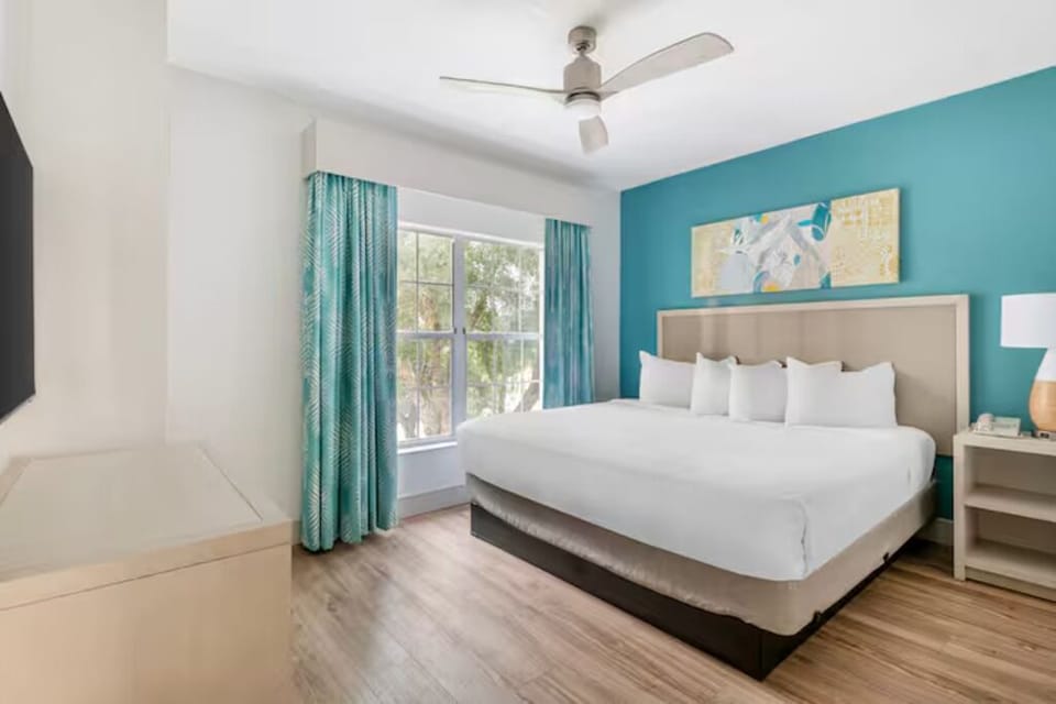 Wake up refreshed in a sunlit bedroom with plush bedding.