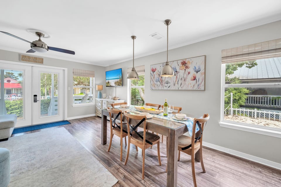 Gather around your bright dining table where pendant lights create the perfect ambiance for memorable meals together.