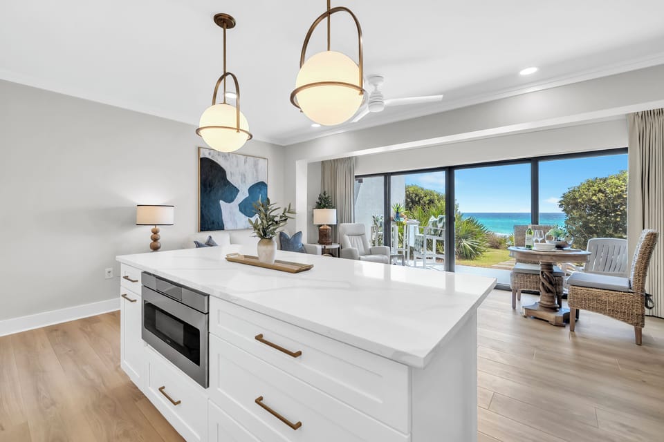 Your gourmet kitchen island opens to stunning ocean views, perfect for morning coffee while watching the waves.