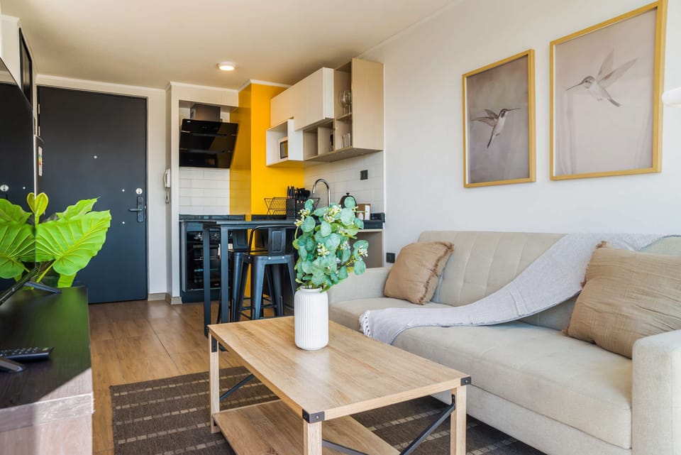 Bright and modern living space with stylish decor and a vibrant kitchen area, perfect for a relaxing stay.
