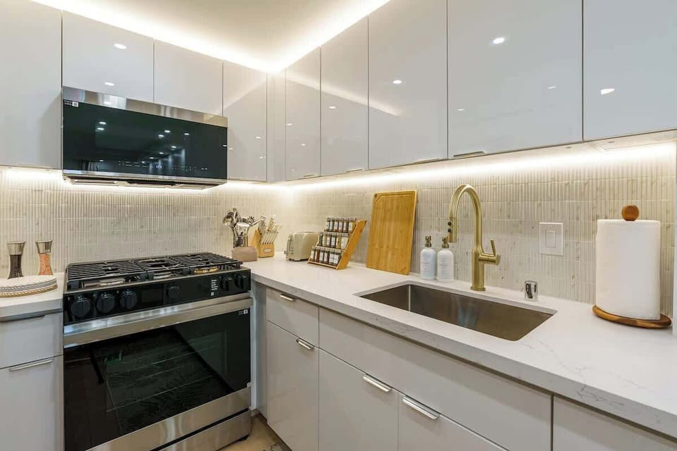 A stunning, chef-inspired kitchen with sweeping quartz countertops that gleam under premium lighting — the perfect centerpiece for culinary creativity. Sleek Samsung® appliances and bar seating create an atmosphere for upscale entertaining..
