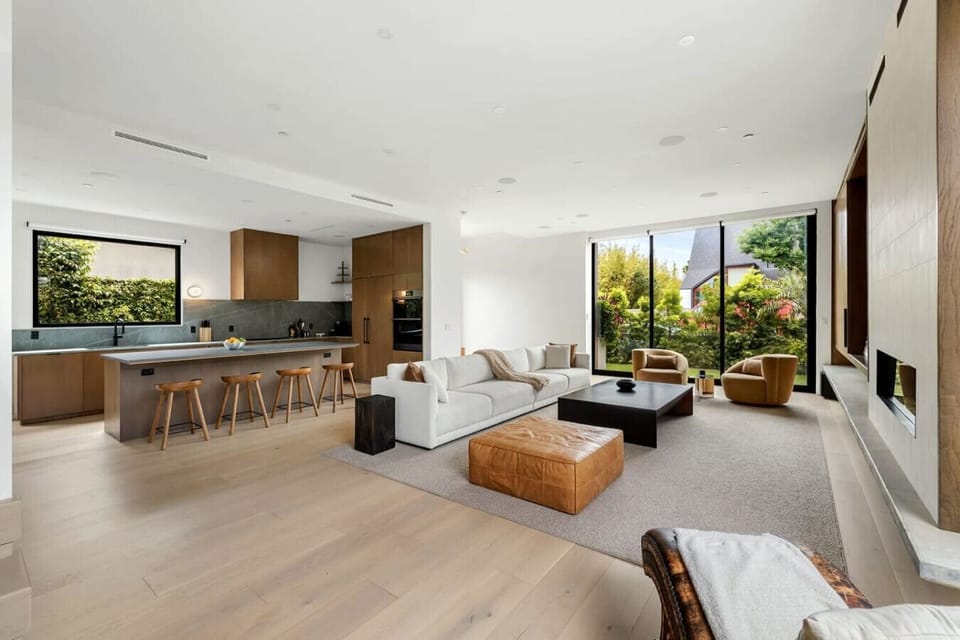 Spacious living room with a seamless view of the dining area, featuring a striking big wall art painting that adds character to the space.