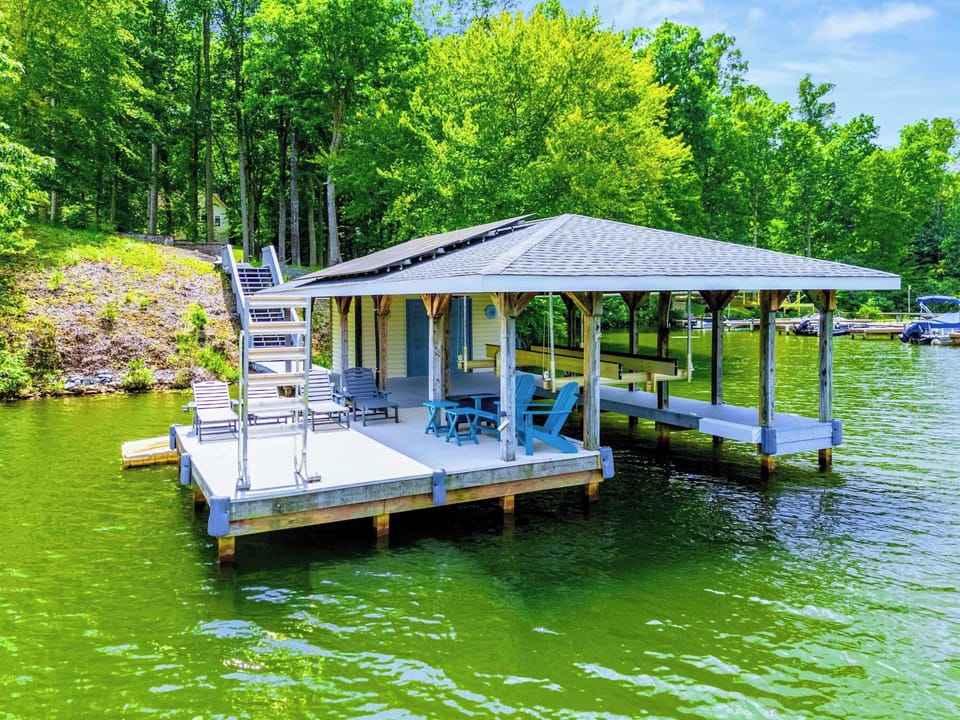 The covered dock pavilion is where the real relaxing happens. Ceiling fan, Adirondack chairs, and nothing but water.