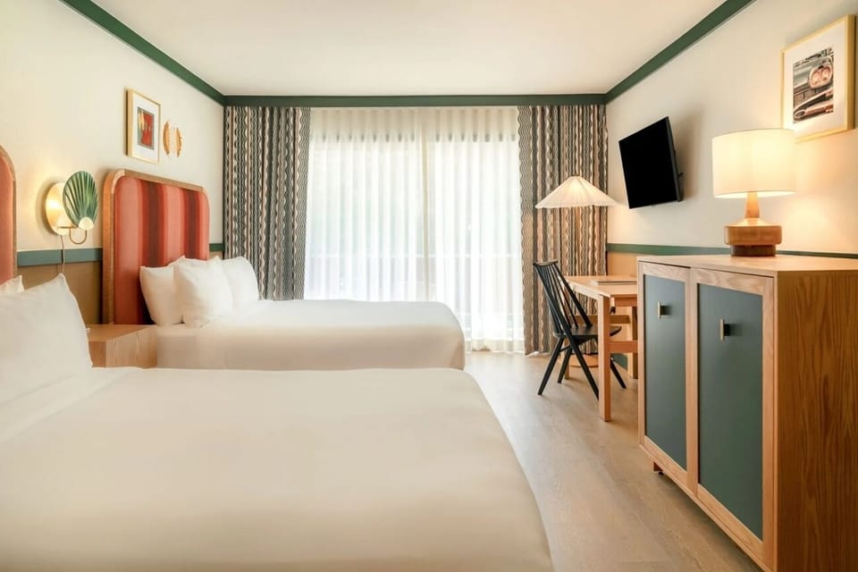 Spread out easily in a bright room with two beds.