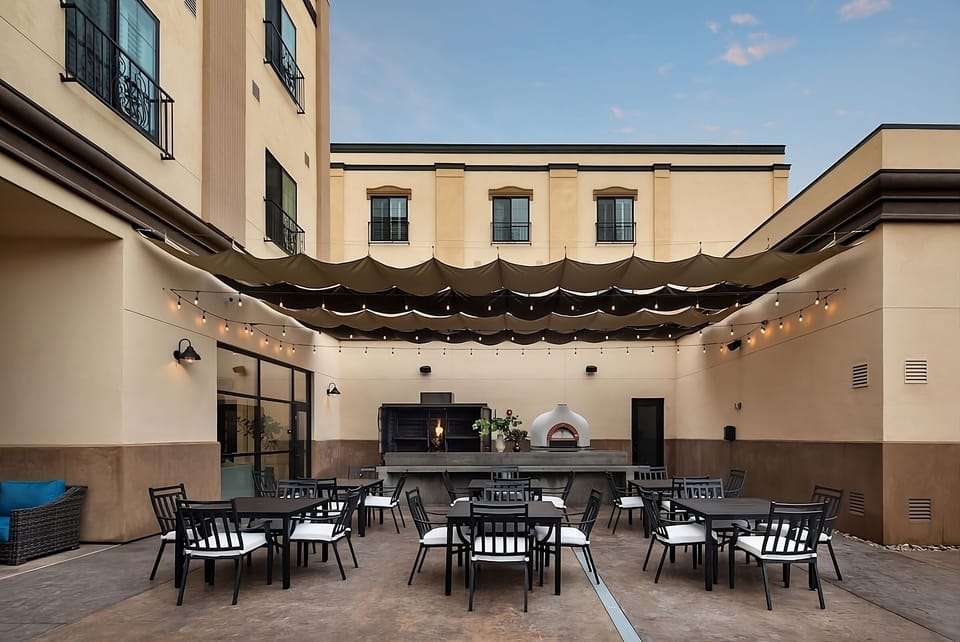 Savor courtyard dinners under twinkling lights and a pizza oven.