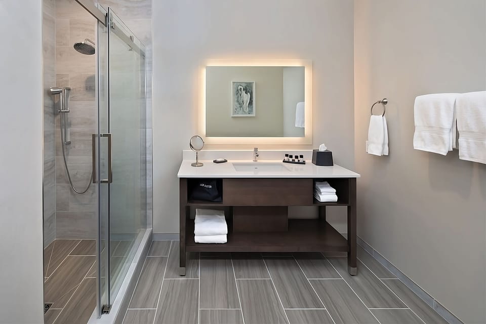 Refresh in a bright, modern bath with glass shower.