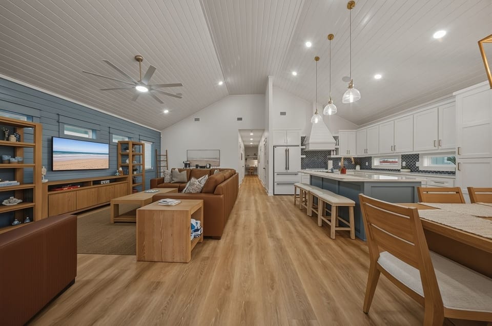 Coastal-chic open concept—gather in the spacious living room, cook in the bright chef’s kitchen, and dine together in style. (Still Waters)