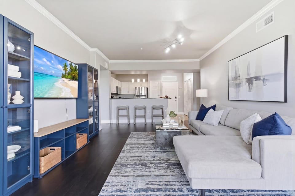 Bright and open living area featuring cozy furnishings, a Smart TV, fireplace, and access to the private balcony.