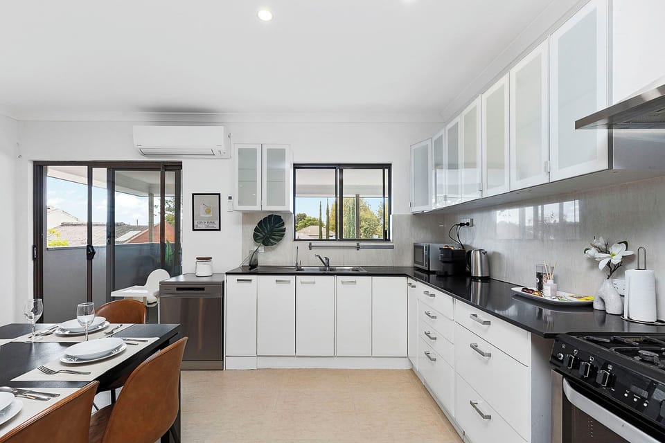 A bright, fully-equipped kitchen with modern appliances and a spacious dining area. Perfect for home-cooked meals and easy living.