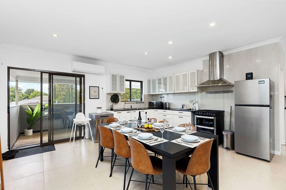 Step into a spacious, light-filled kitchen and dining area.
