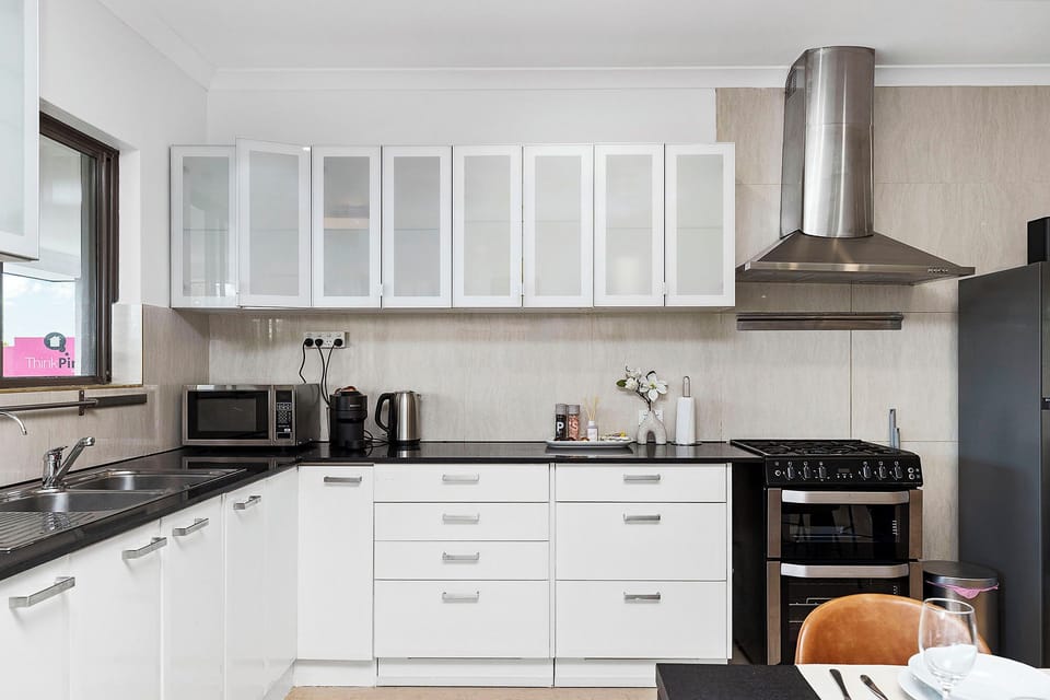 A chef’s delight! This modern kitchen is fully equipped with sleek cabinetry, premium appliances, and all the essentials you need to whip up a delicious meal during your stay.