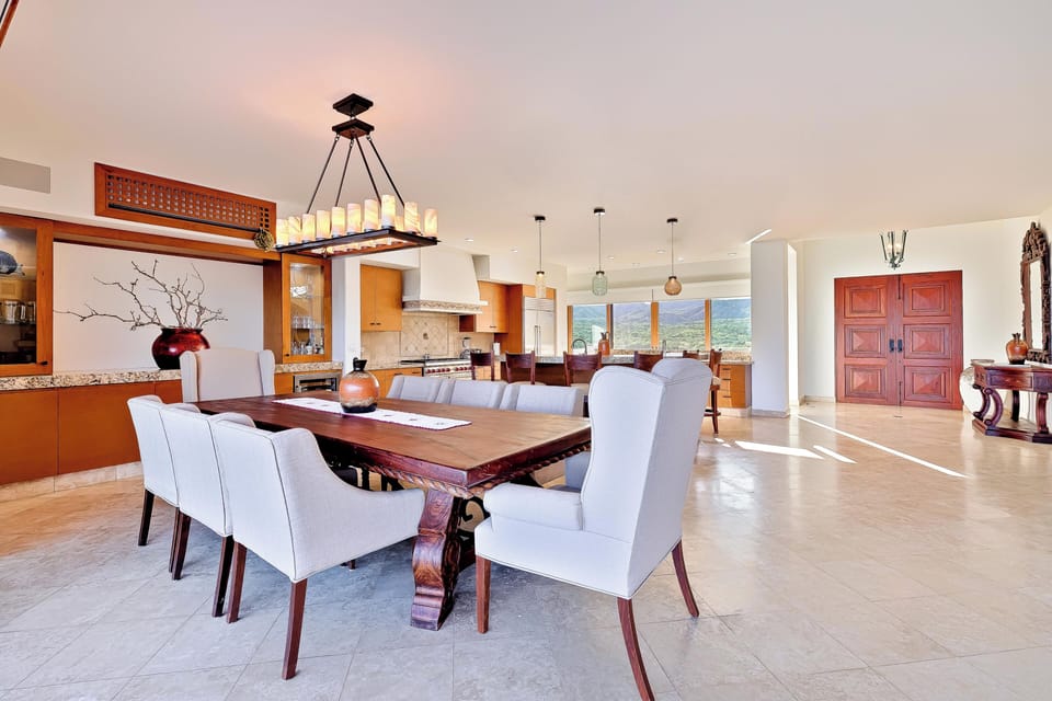 Gather around this stunning dining table where rich wood meets elegant comfort, while mountain views create the perfect backdrop for memorable meals together.