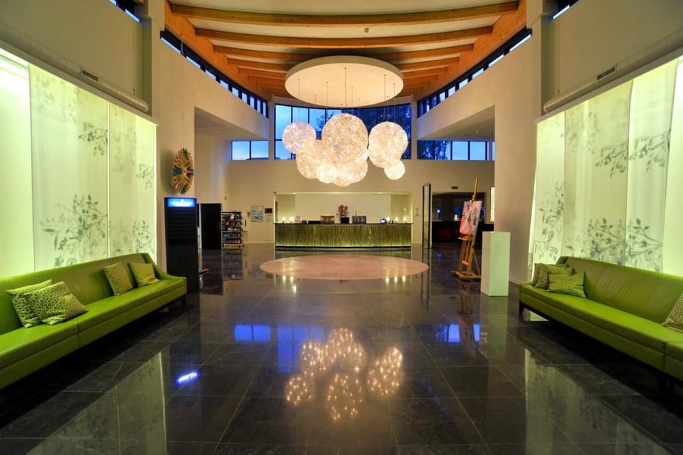 Arrive to a dramatic lobby, bright art, and calm vibes.