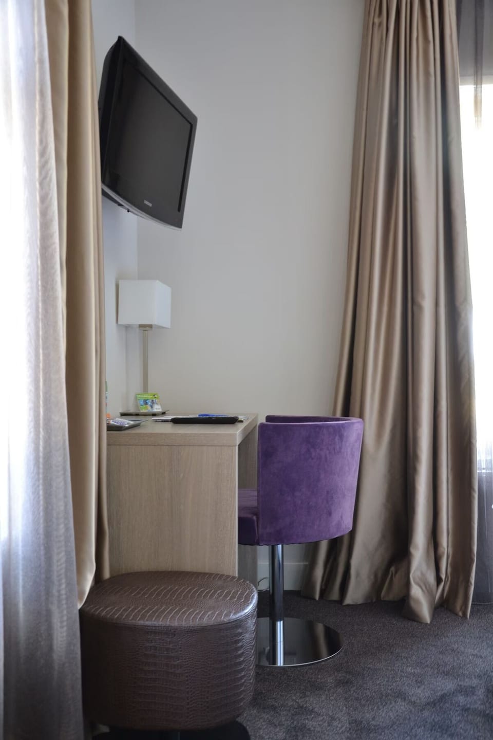 Catch up on emails at a cozy desk with TV.