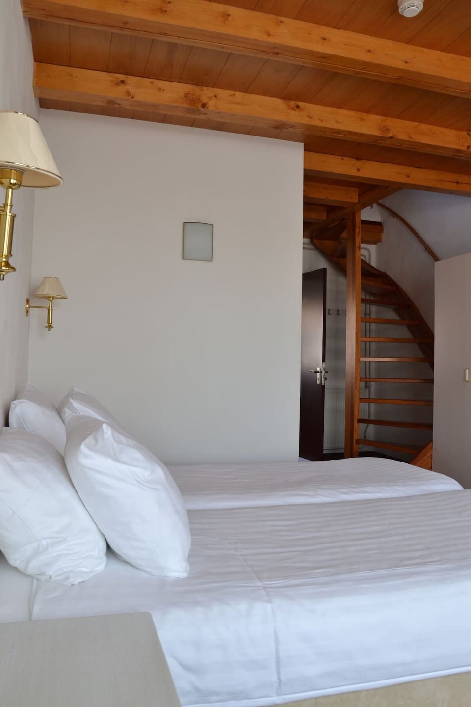 Wake up refreshed beneath warm timber beams and crisp linens.