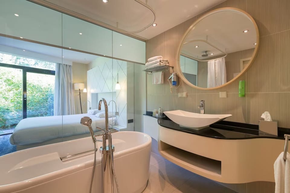 Indulge in a deep soak beside a glossy designer vanity.