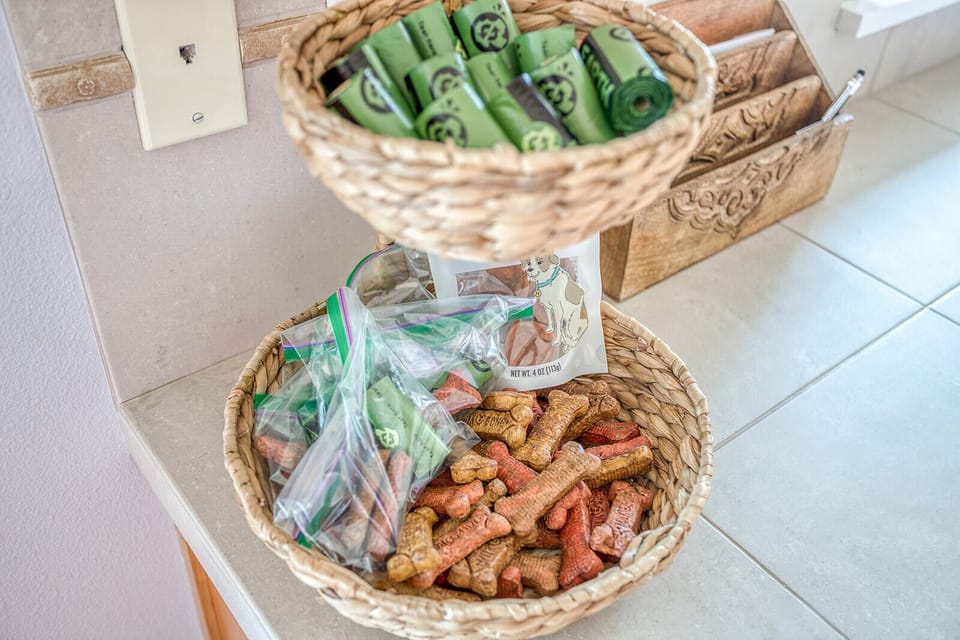 Thoughtful pet amenities await your furry friend with treats and toys in charming wicker baskets.