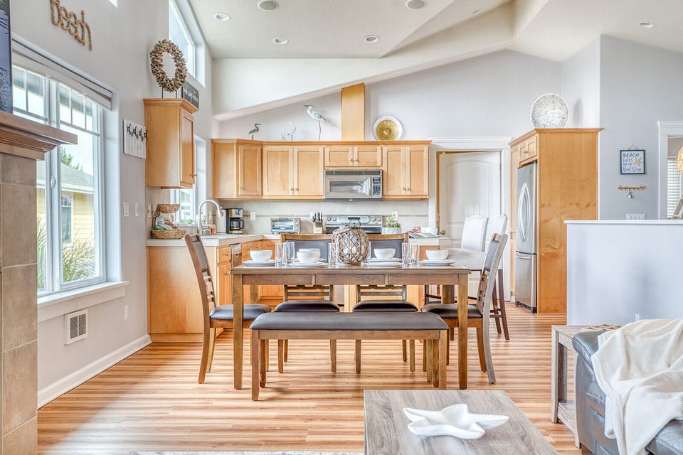 Your open-concept kitchen and dining area features warm wood cabinets, stainless appliances, and a welcoming table perfect for shared meals.