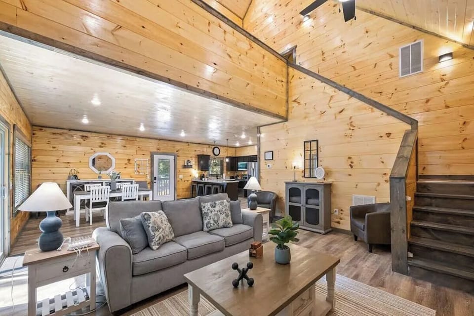 Relax in your cozy cabin retreat with plush sofas and an open-concept design that flows from living to dining areas.