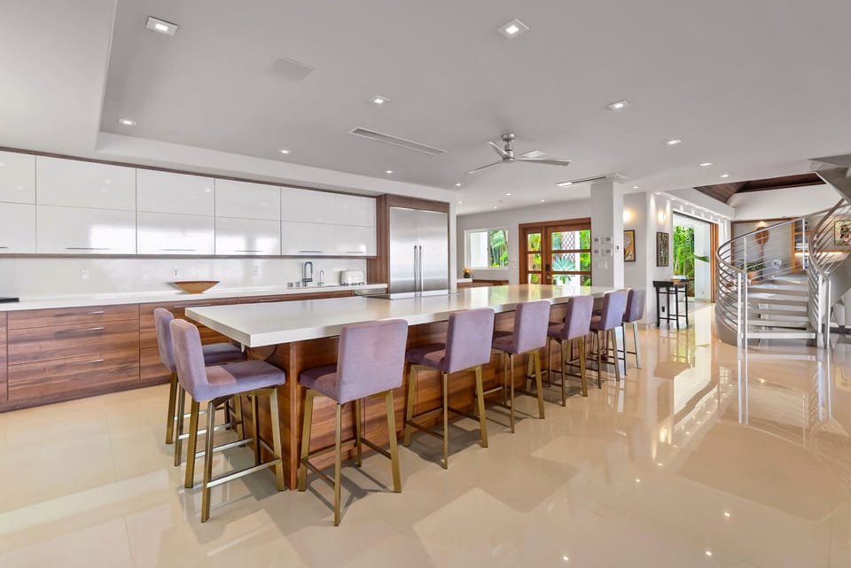 Gather around this stunning kitchen island where sleek modern design meets warm wood tones. With seating for ten, you'll create unforgettable meals and memories in this chef-inspired space.