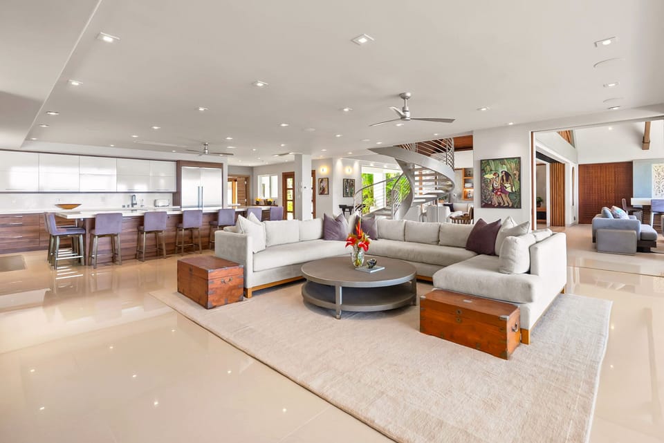 Unwind in this bright, open-concept living space where modern elegance meets comfort. Plush seating, a spiral staircase, and a fully equipped kitchen invite you to relax and feel right at home.