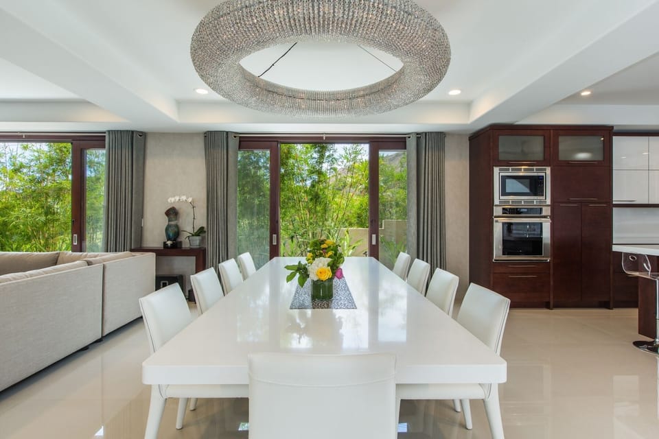 Formal dining space with natural light and modern finishes for elevated in-home dining.