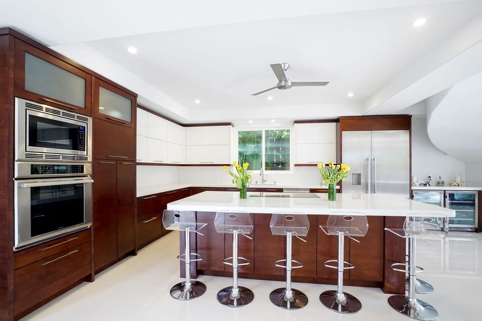 Chef’s kitchen with breakfast bar, stainless appliances, and sleek, modern design.