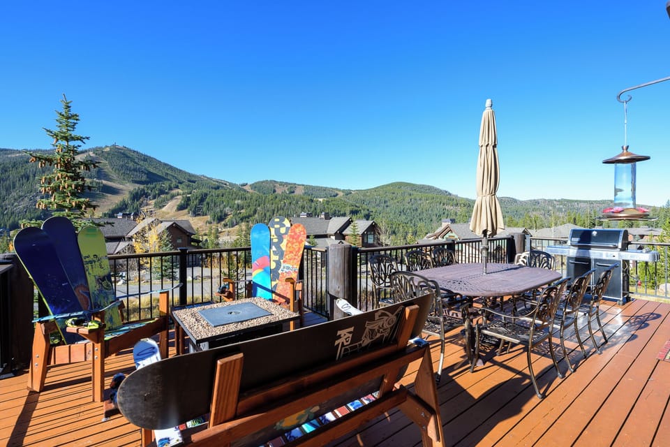 Stunning mountain views from this spacious deck with dining and BBQ setup - perfect for memorable outdoor gatherings.