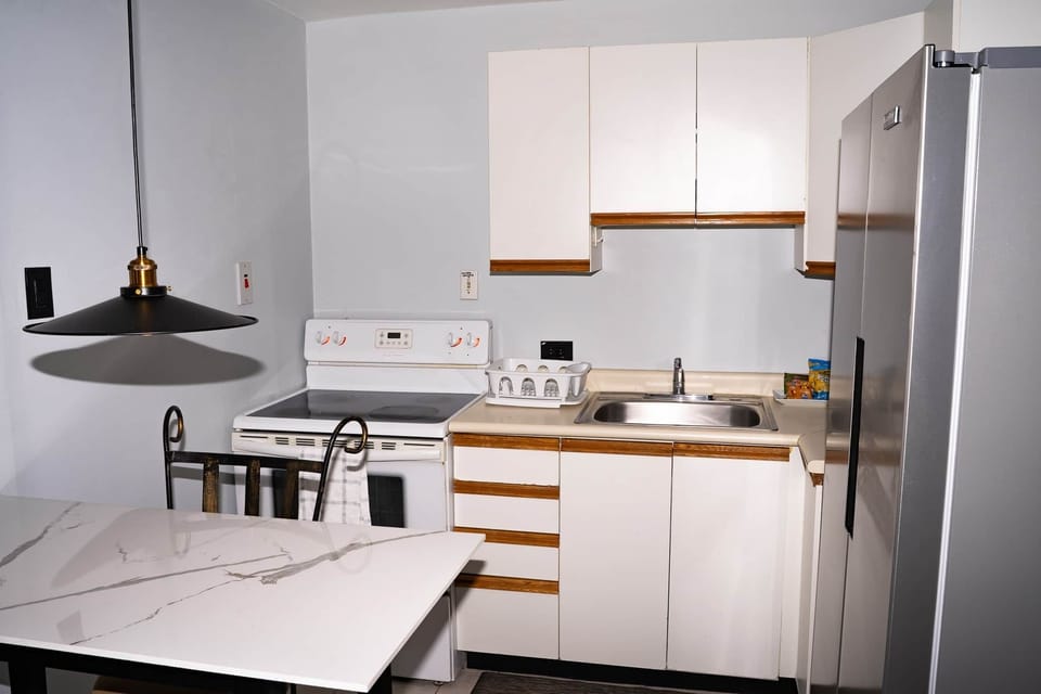 Full electric stove, side-by-side fridge & marble counter for home cooking