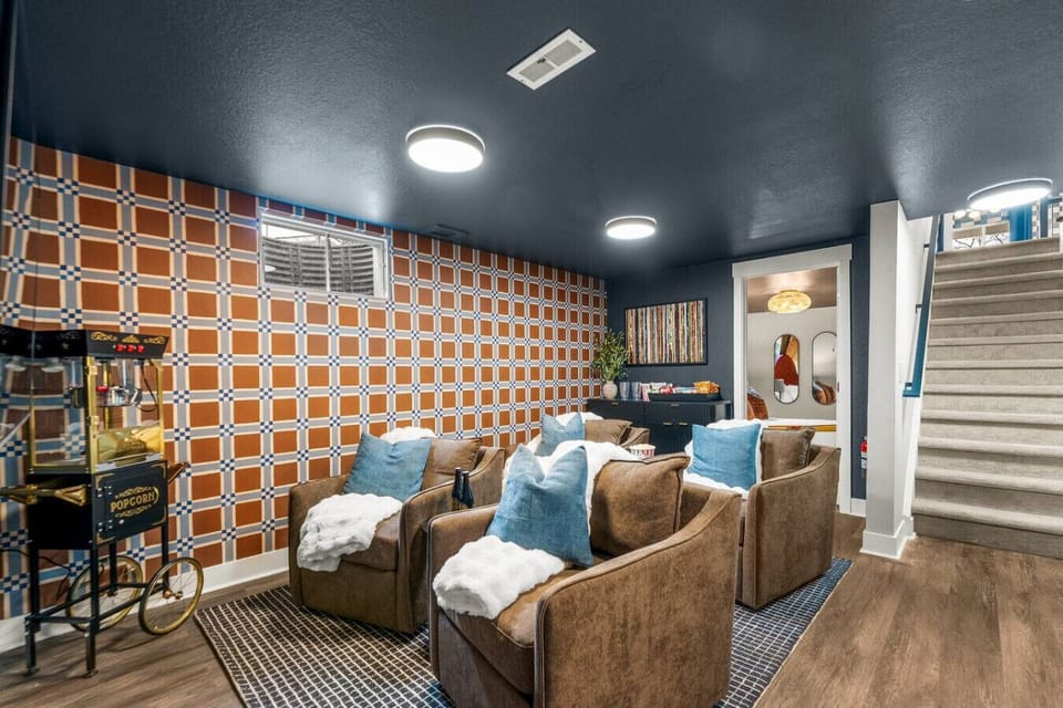 Theater room with cozy lounge seating, smart TV, and popcorn machine