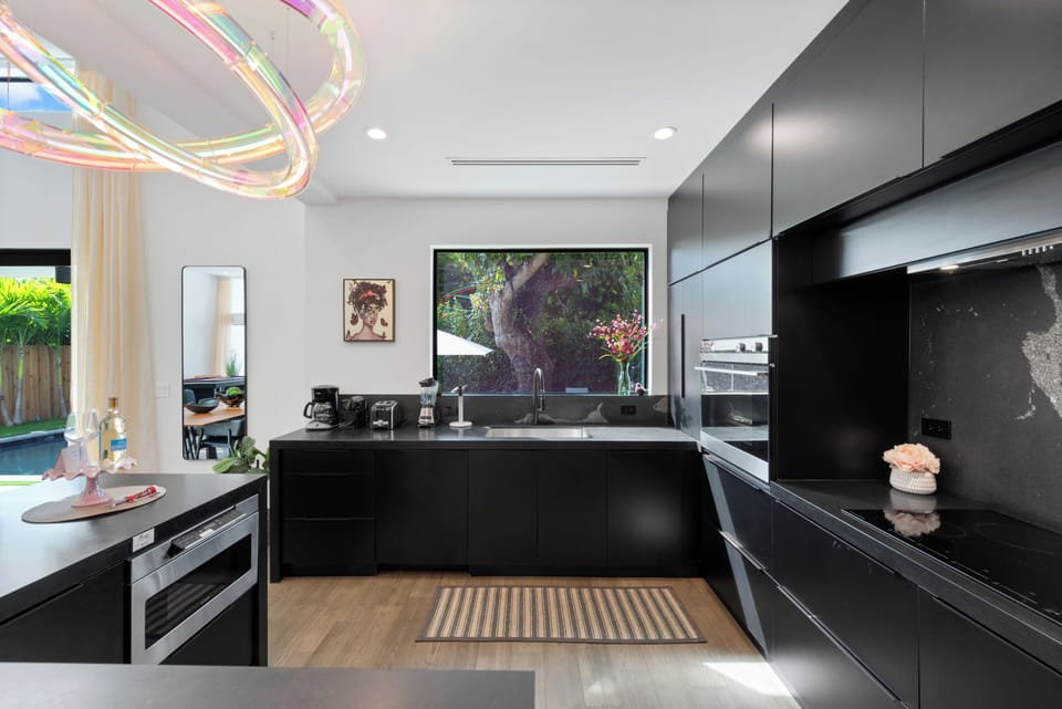 Full kitchen with full range of appliances and pool view.