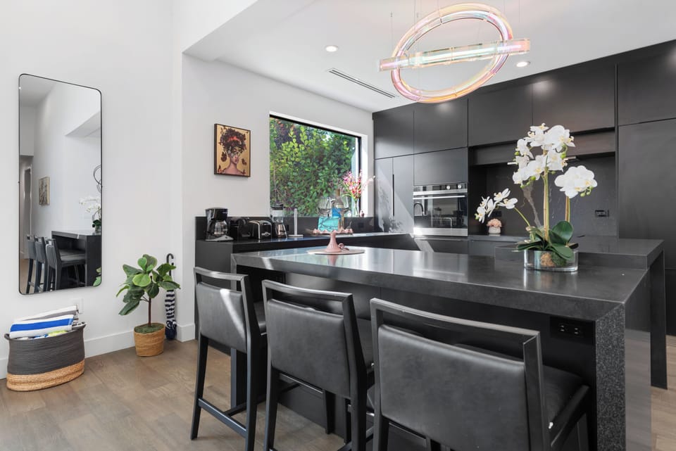 Stylish modern kitchen with waterfall island and chic designer lighting