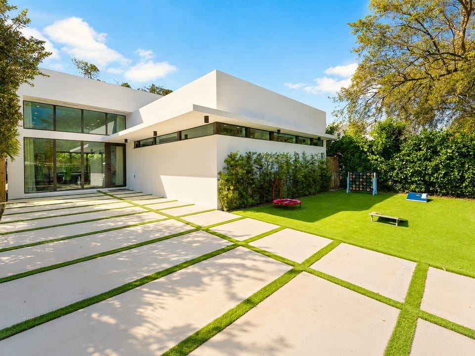 The front-exterior of our home with a gated driveway and yard for activities.