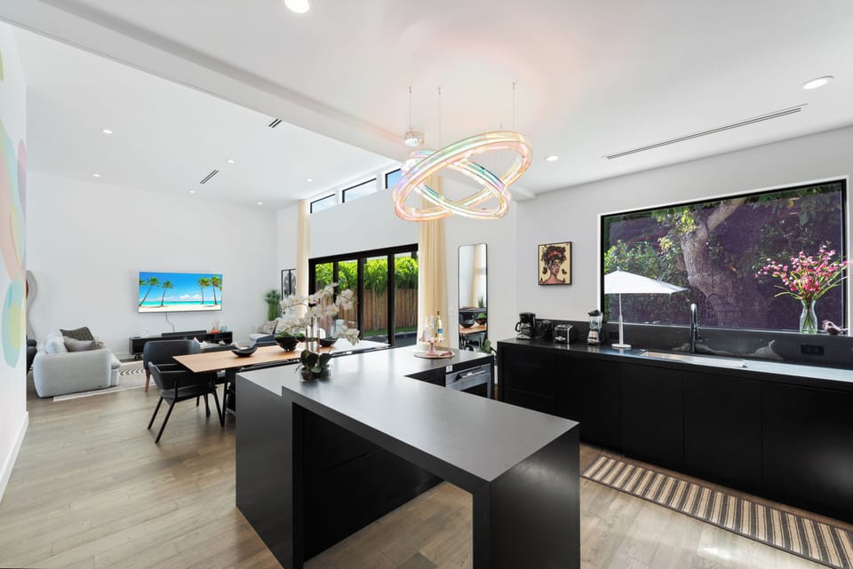 Our open-concept kitchen, dining area and access to the pool deck