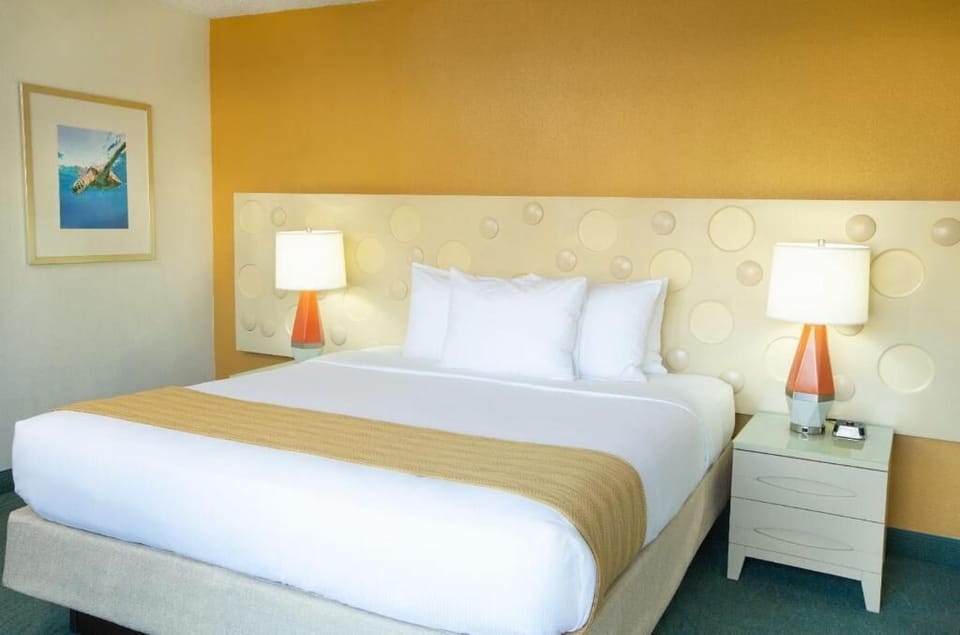 Drift off under soft lamps and a warm, welcoming headboard.