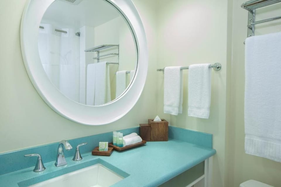 Refresh easily with a spotless vanity and plush white towels.