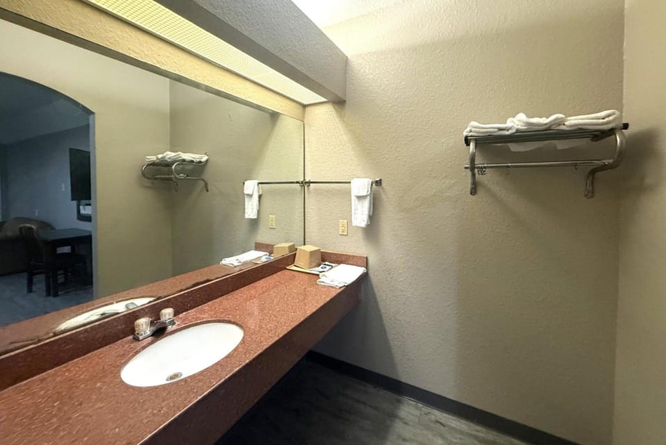Refresh at the wide vanity with bright mirror lighting.