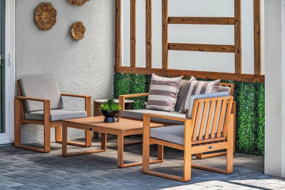 Screened-in pool area w/ patio seating, ideal for soaking up the sun.