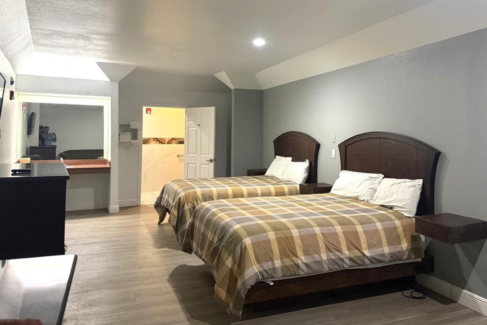 Unwind in a spacious double-room with plush beds and calm lighting.