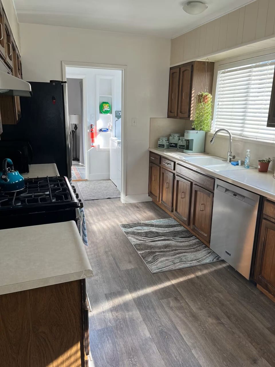 Fully stocked kitchen leading into the laundry room