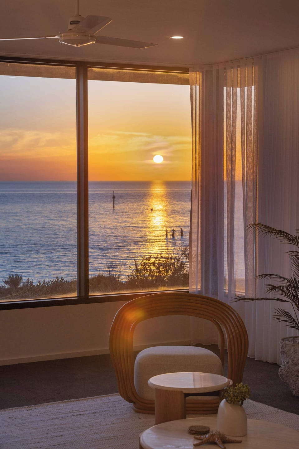 The sun sets directly in front of the home, across Port Phillip Bay
