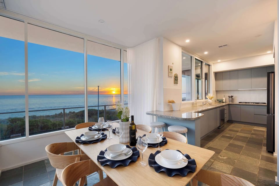 The second dining area, leading into the open kitchen. The desk and study area is also located in this area – all surrounded by stunning views