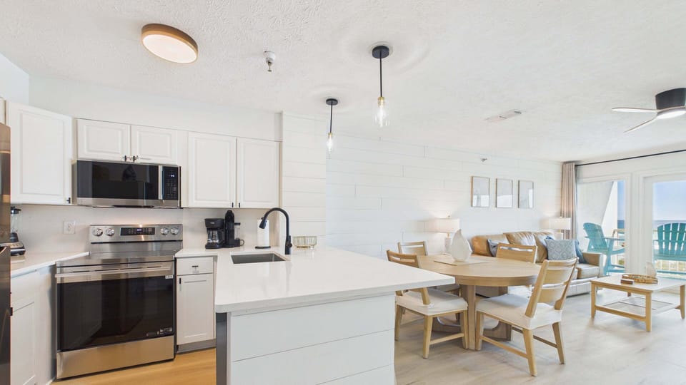 Fully applianced kitchen with ample counter space and breakfast bar for all the culinary desires
