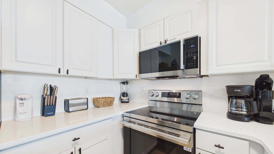 Fully applianced kitchen with ample counter space and breakfast bar for all the culinary desires
