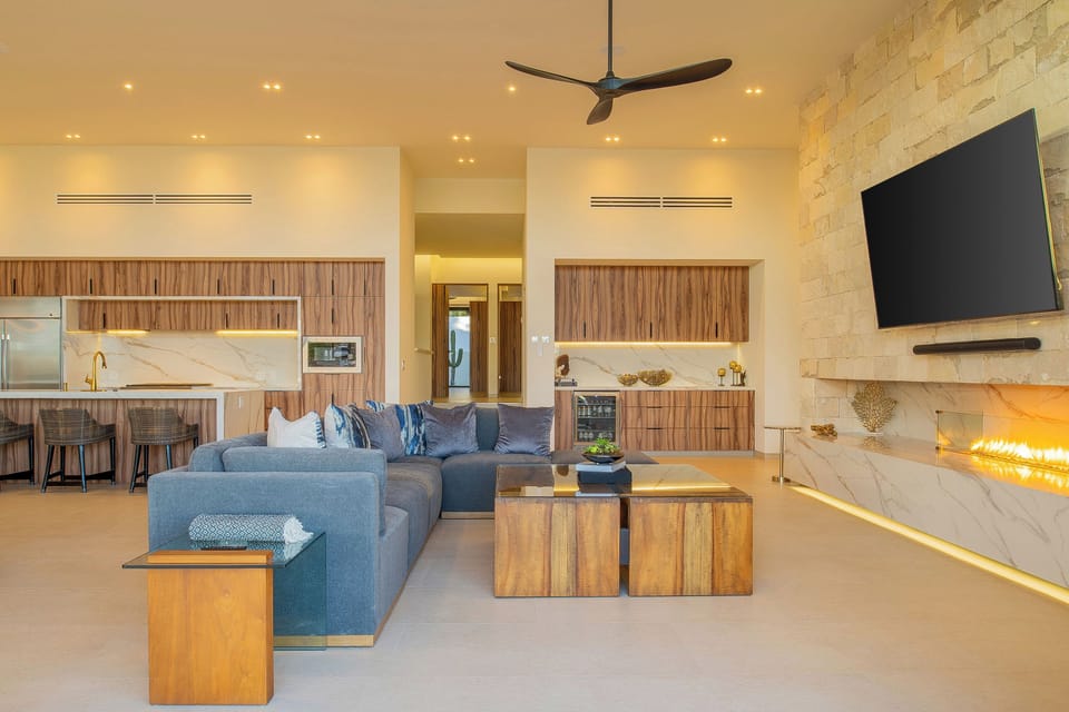 Sink into plush seating while flames dance in your modern fireplace. The open kitchen beckons for cooking adventures in this luxurious retreat.