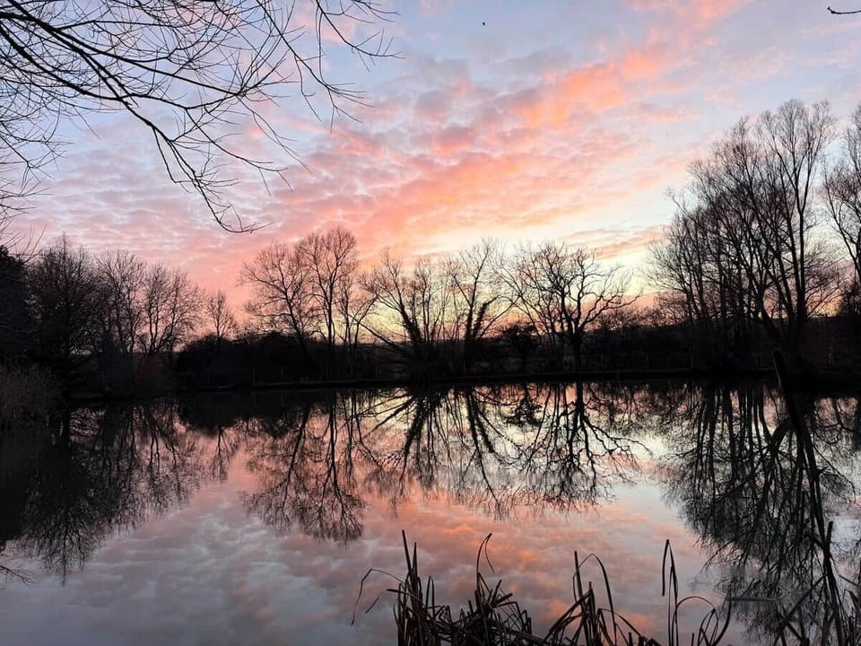 Stunning sunset views over the private fishing lakes at Chad Lakes, a short walk from Fleece Lodge.