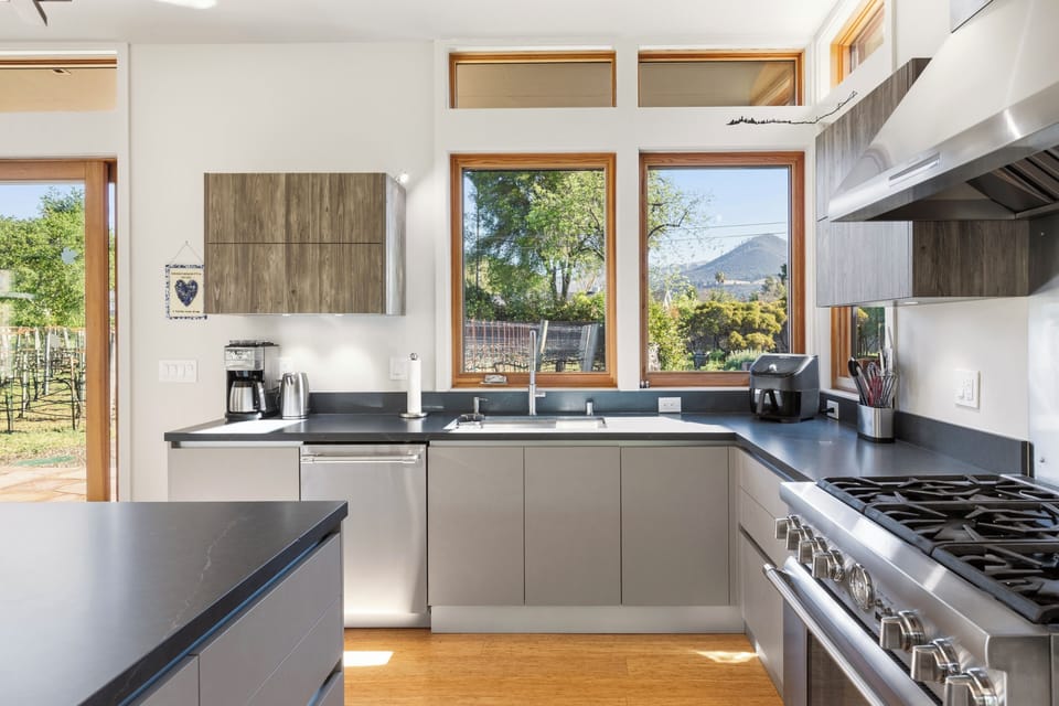 Your modern kitchen features premium appliances and stunning mountain views through large windows, creating the perfect space for culinary adventures.