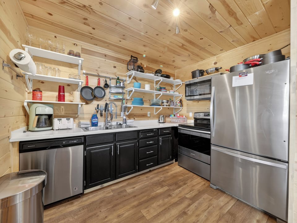 Your fully equipped kitchen features stainless steel appliances and rustic wood beams, perfect for preparing memorable meals during your stay.