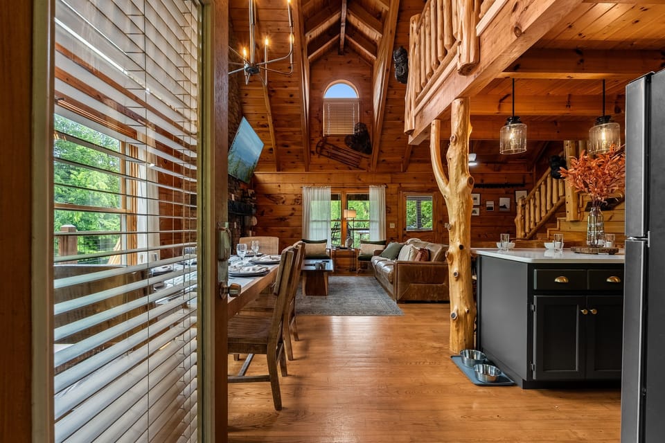 Step inside and immediately feel the warmth of this beautifully refreshed log cabin, featuring soaring vaulted ceilings, an open-concept living space, rustic wood finishes, and thoughtful family- and pet-friendly touches throughout.